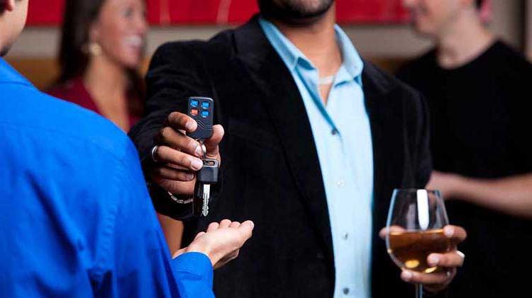 Man with wine glass handing over car keys.