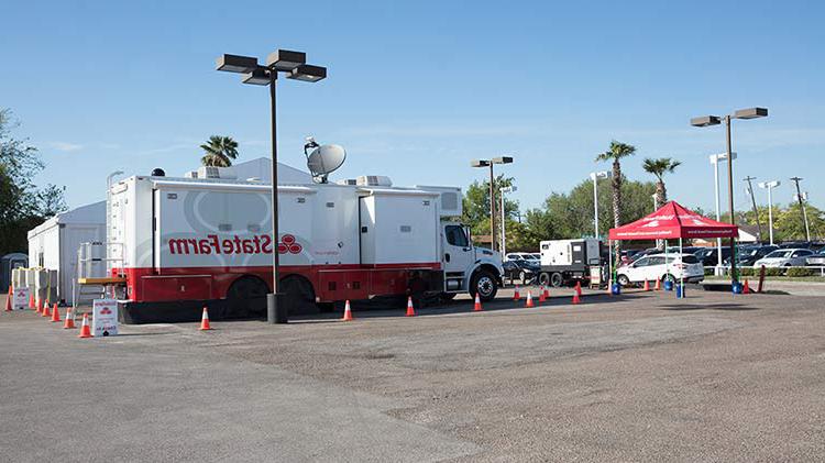 State Farm catastrophe vehicle in a parking lot.